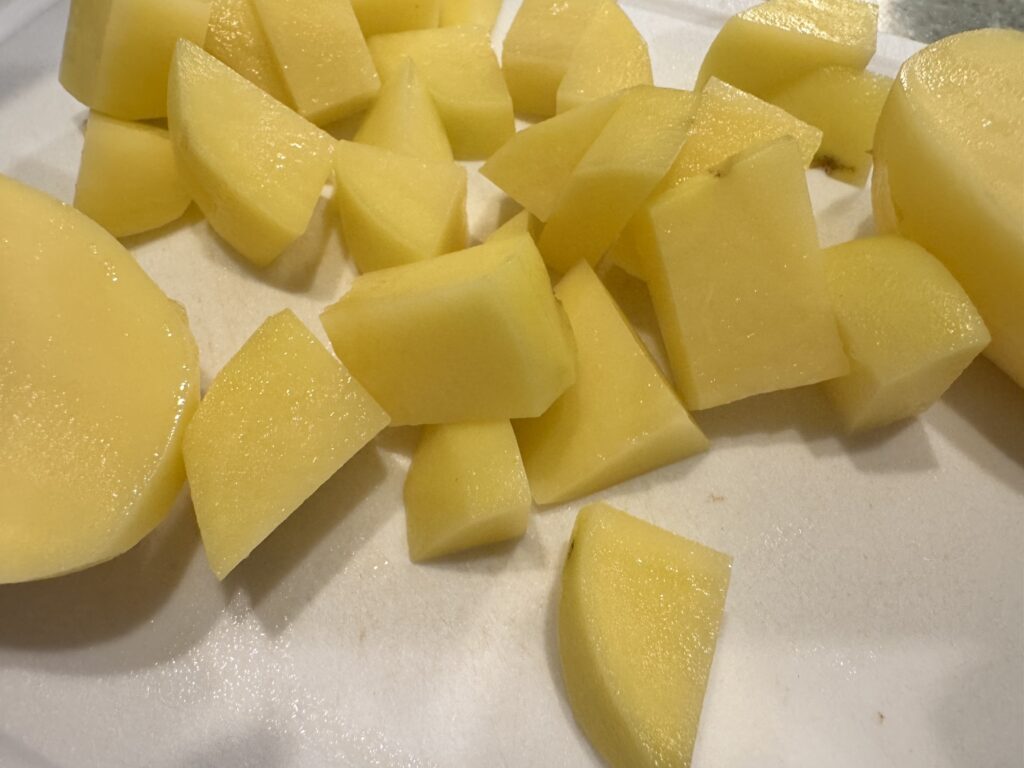 large chopped yukon gold potatoes on cutting board