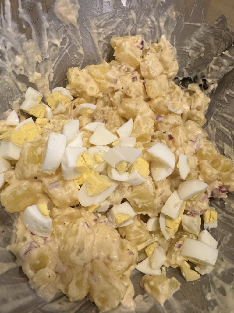 chopped hard boiled eggs in a potato salad