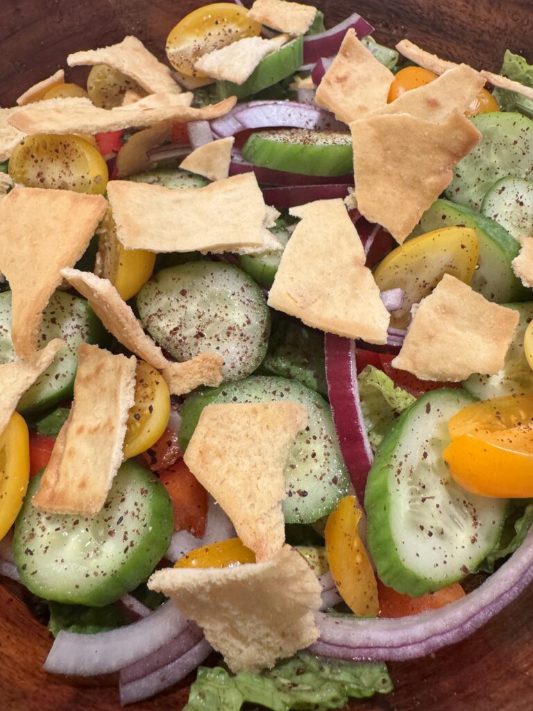 salad and pita chips in a serving bowl