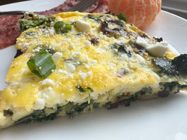 frittata breakfast plate with turkey bacon and an orange