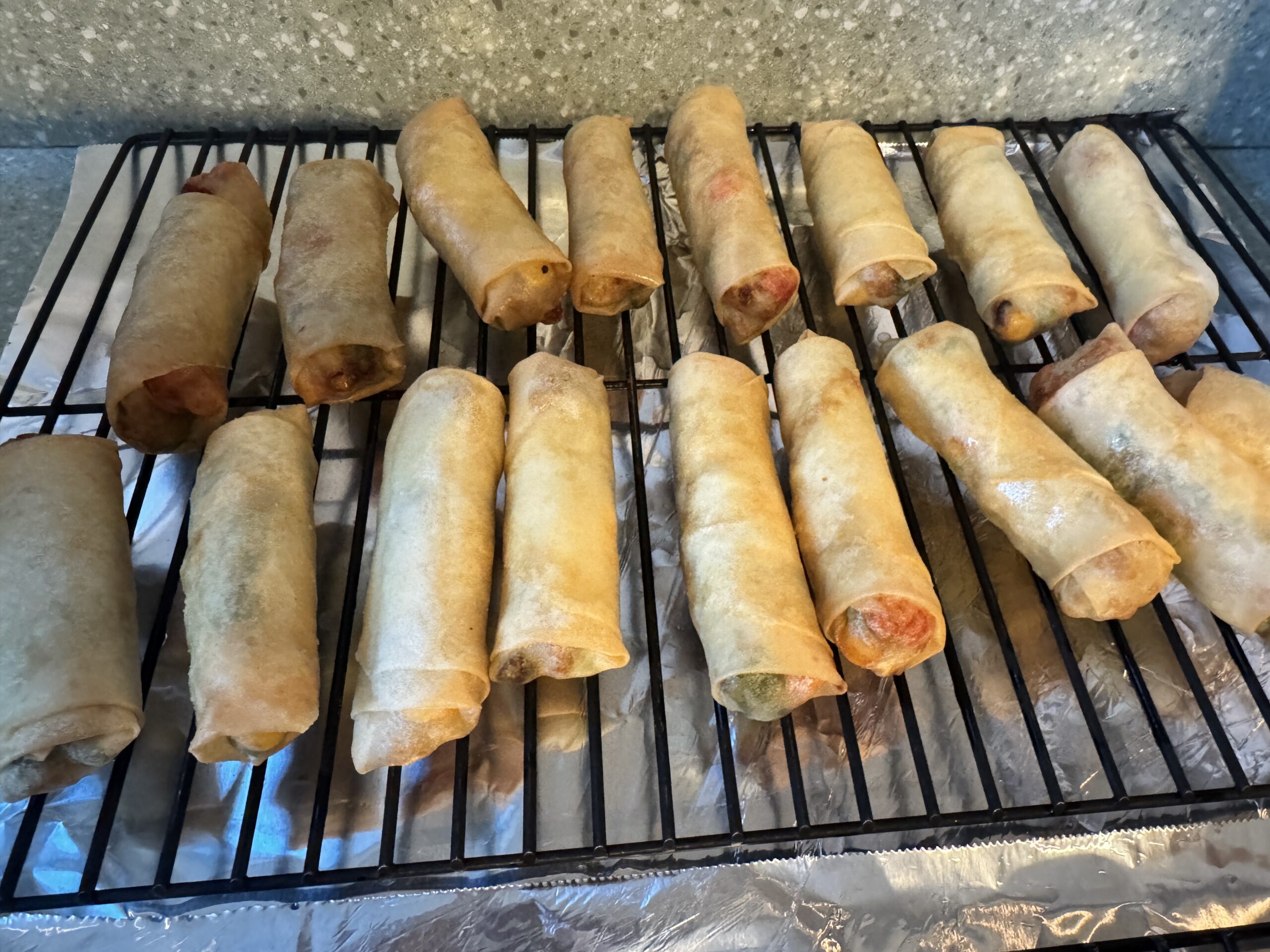 fried chicken egg rolls on a wire rack