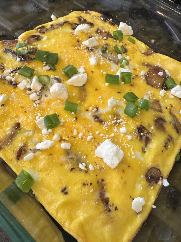 veggie frittata topped with feta cheese and green onions