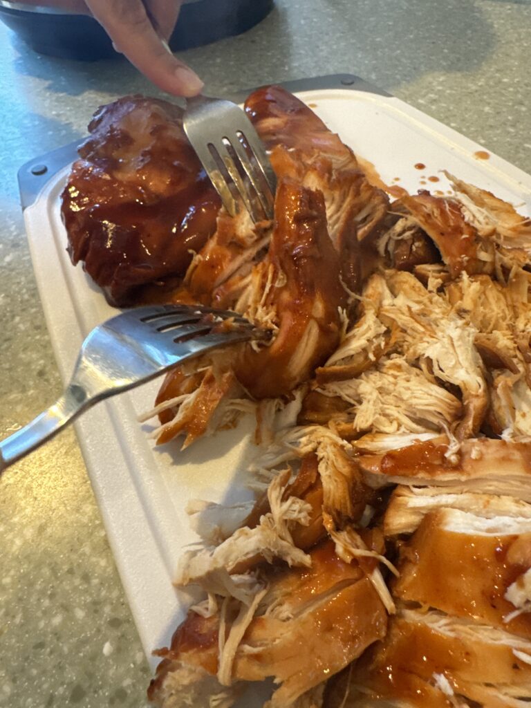 Shredding BBQ pulled chicken with forks