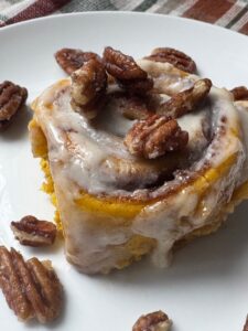 Pumpkin cinnamon rolls with candied pecans
