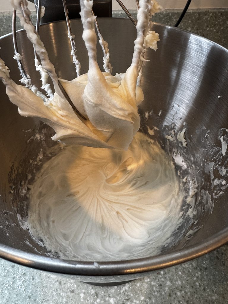 cream cheese frosting in kitchen aid stand mixer with whisk attachment
