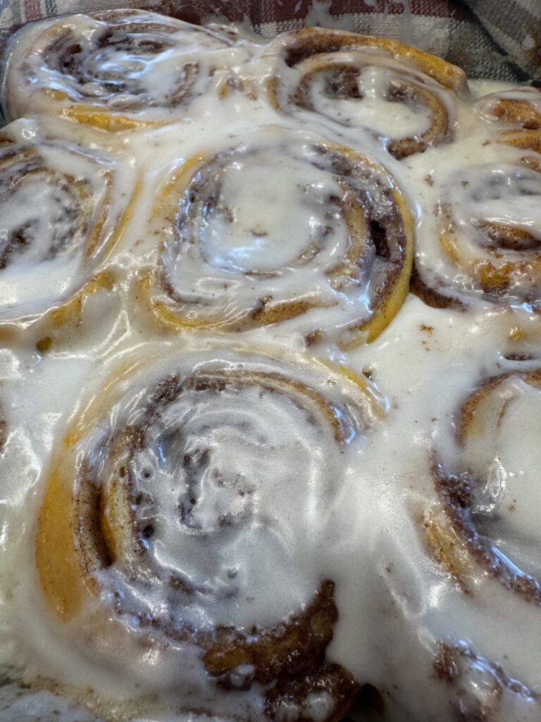 frosted pumpkin cinnamon rolls with cream cheese frosting
