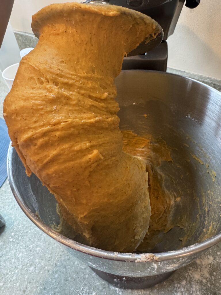 pumpkin rolls dough in stand mixer on hook attachment