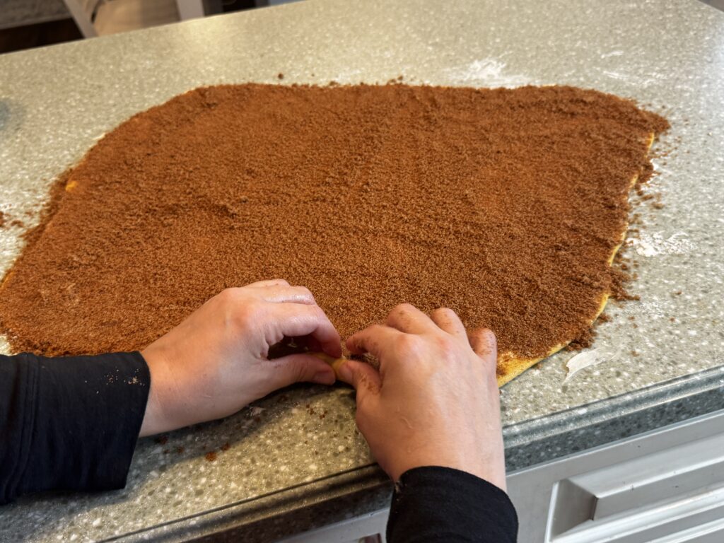 rolling pumpkin cinnamon rolls starting on the right side