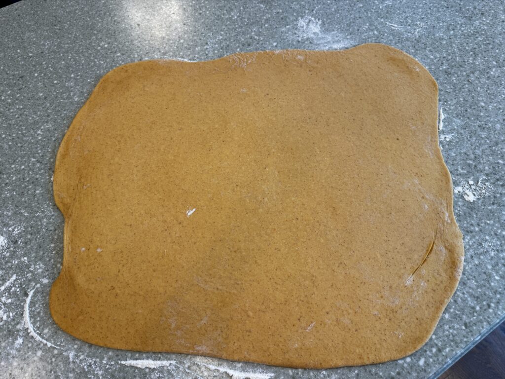 rolled out pumpkin cinnamon roll dough